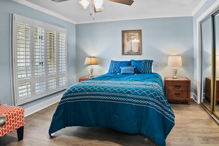 First floor guest bedroom with queen bed.