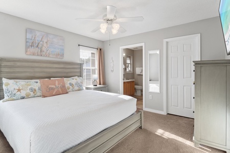 Bright and serene primary bedroom with a king bed, ensuite bath, and coastal touches—your perfect private retreat after a day in the sun.