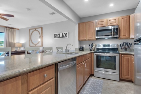Kitchen has granite countertops with stainless steel appliances.