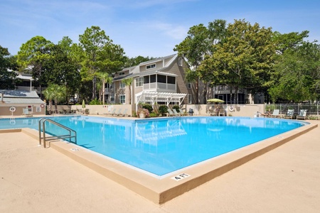Dive into relaxation at the resort-style pool, surrounded by shade trees, loungers, and peaceful charm.