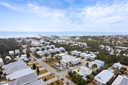 An aerial view of a neighborhood with house and beach entrance marked..