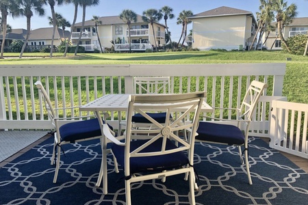 Deck with outdoor seating and view of golf course