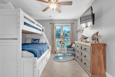 Guest bedroom with twin over a full bunk bed, twin size trundle and flatscreen television.