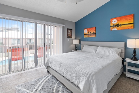 Primary bedroom with king bed and private balcony.