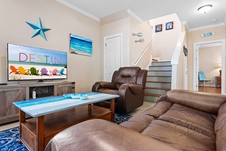 Living room with comfortable leather seating and flatscreen television.