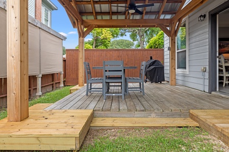 Private backyard with covered pergola and outdoor dining