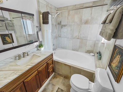 Master bedroom private bathroom features a tub and shower.