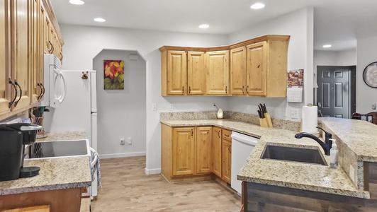 Spacious kitchen with over, refrigerator, and dishwasher