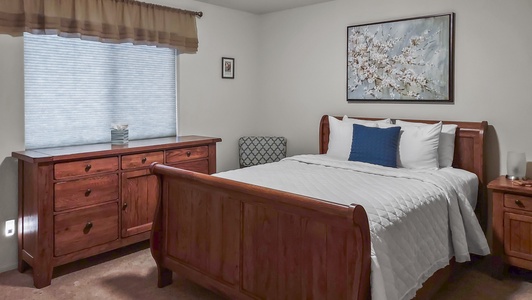 Spacious master bedroom with queen bed