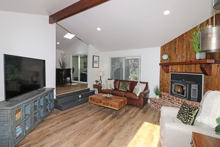 Spacious living area with fireplace and smart TV