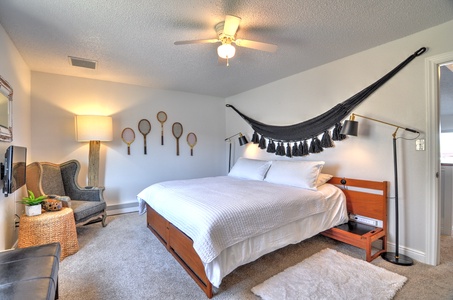 Master bedroom with comfy king bed, smart tv, walk-in closet, and private attached full bathroom