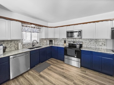 Creatively designed kitchen with all amenities. Full stove, refrigerator, dishwasher, and washer and dryer.