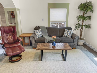 Cozy living room with smart tv, some books and games. 