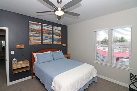 Master bedroom with queen bed and private balcony