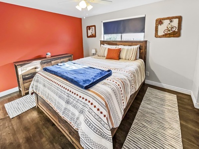 Comfy queen bed in master bedroom with attached private bathroom.