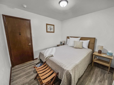 Beige Bedroom with comfy queen bed and walk-in closet. 