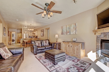 The living room features windows facing the slopes which allow for an abundance of natural light to flood in. 