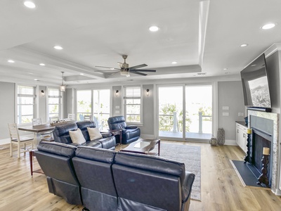 Open living room with floor to ceiling windows & doors