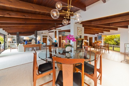 Open living space features casual elegance everywhere you look. There are beautiful furnishings throughout the house. This view is looks from formal dining area towards casual dining area, living room and kitchen