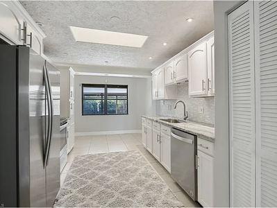 Modern kitchen with stainless steel appliances - kitchen furniture being added