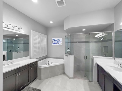 Master Bath Bathroom with 2 separate sinks, tub, standup shower, linen closet outside of bathroom and large walk in closet