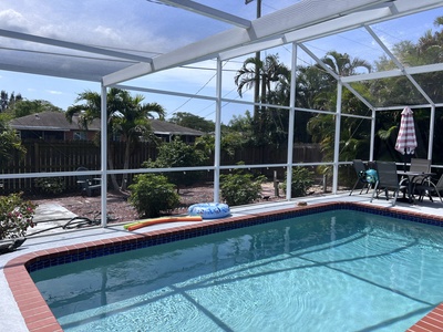 Inground Pool with Screen Next to outdoor open air patio