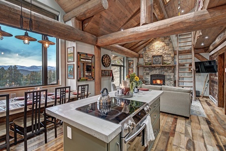 Majestic main room Majestic main room A modern kitchen with amazing views shares space beneath impressive support logs with the coziest living room ever.