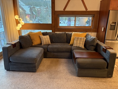 Relax in style on this spacious sofa, complete with an ottoman and chaise—perfect for accommodating your whole crew!