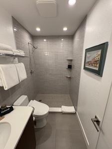 Step into serenity: This brand new modern bathroom offers spa-like luxury with a stunning subway tiled walk-in shower, a sleek bidet toilet, and an elegant quartz-topped vanity