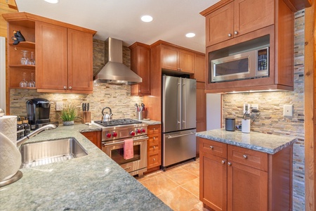 Discover an updated, efficient kitchen featuring modern stainless appliances and sleek quartz countertops for both style and functionality.