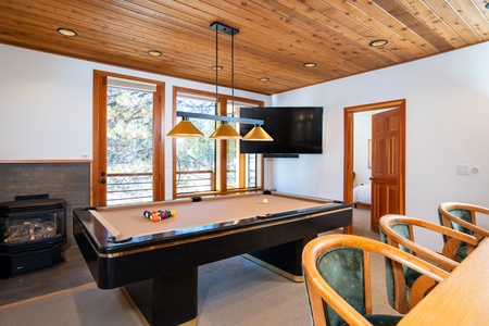 Welcome to your beautiful bonus room featuring a new flat-screen TV, a cozy wet bar with seating, and a fun pool table—perfect for entertaining and relaxation!