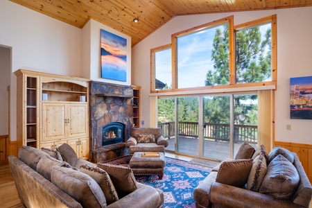 Enjoy the warmth and depth of this grand room and its open floor plan. The cathedral ceiling, wall of windows and large rock mantel gas fireplace offers breathtaking views from just about any spot in the room!