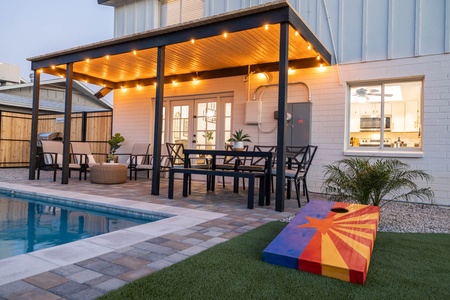 Desert sunshine splashes the pool by day, and at night, light strings cast a glow on the barbecue and outdoor seating.