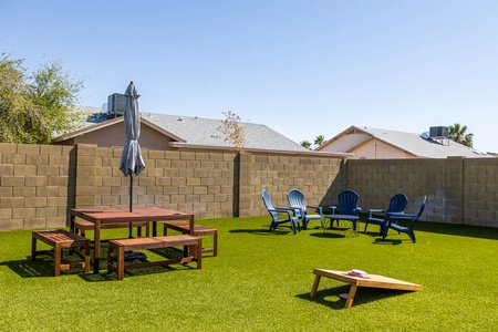 Large outdoor space with dining area, extra seating and corn hole for hours of fun!