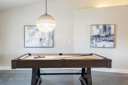 Unwind in the game room with a stylish pool table, perfect for casual or competitive play