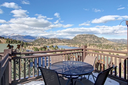 Patio seating on the condo's deck surrounded by beautiful lake and mountain views.