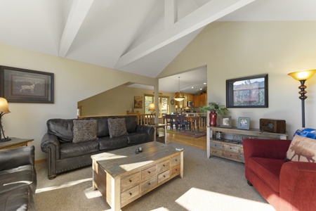 Large open concept living room, featuring vaulted ceilings. 