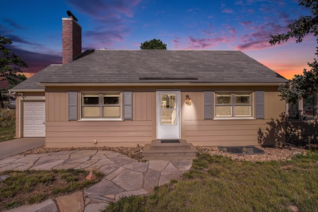 Your Vacation House Estes Park Exterior View of home and front door, at twilight.