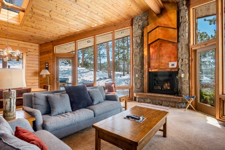 Open concept Great Room with a fireplace, couch and loveseat 