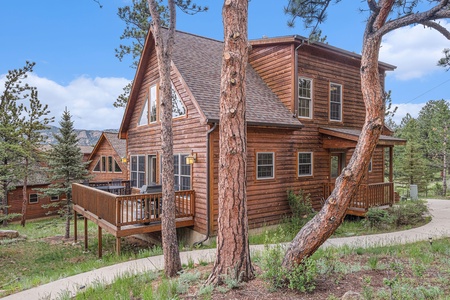 Exterior of cabin, with back deck and front porch.