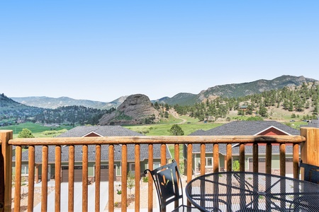 Private deck with mountain view, offers extra seating for outdoor dining.