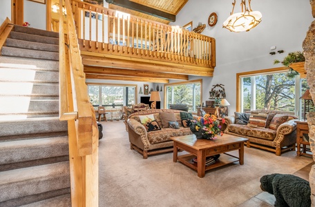 Open concept floor plan - Living and dining rooms with stairs leading to the loft