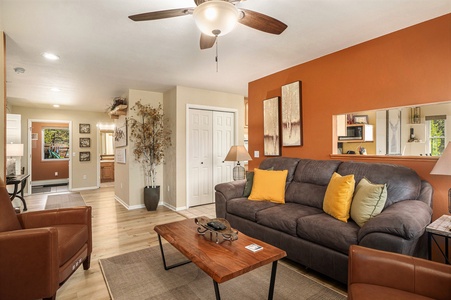 Cozy living room with a peak through window to the kitchen.