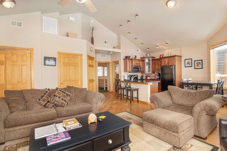 Comfy queen sleeper sofa and oversized chair with ottoman open to kitchen/dining area. 