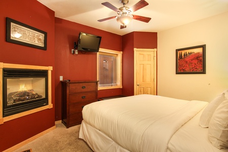 Master suite with King bed, gas fireplace, and flat sceen TV.
