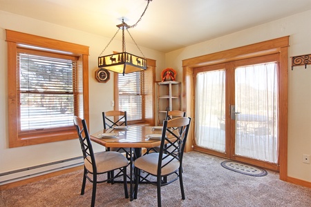 The dining area features a table with seating for four