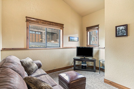 Timber Mountain Retreat Estes Park, Living area on lower/entry level, sofa seating and flat screen TV.