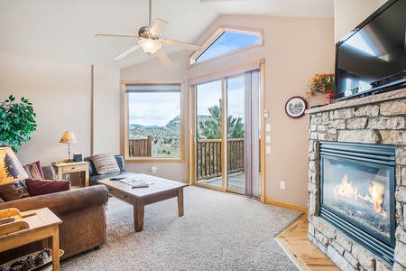 Living room with queen sleeper sofa, leather chair, fireplace and flat screen TV.  Open up the sliding door for fresh mountain air. 