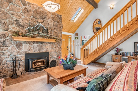 Living room with stairs leading up to the loft