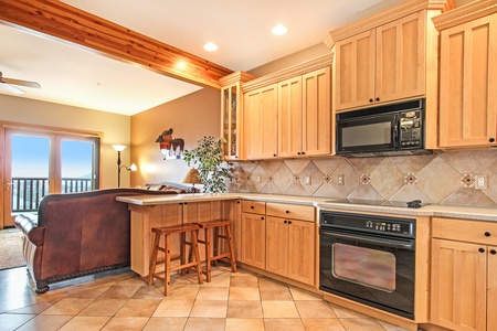 Open concept kitchen/living space. Living room sofas just adjacent to kitchen and countertop seating.